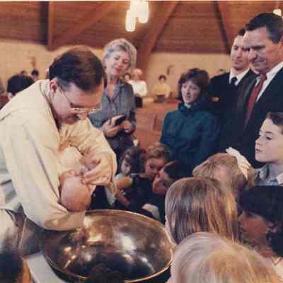 A photo view of a baby being baptised. 4/10/1989.
