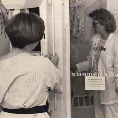 A photo view of Teri Cole adjusting the X-ray machine. 10/20/1992.