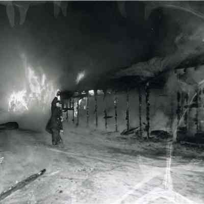 A photo of one of the animal sheds burning.