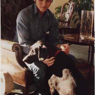 A photo view of a boy and his dog. 1/21/1987.