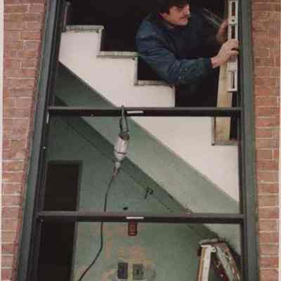 A photo view of a carpenter at work. 1/29/1987.