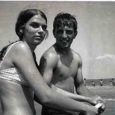 A B/W photograph of a young couple on a beach.