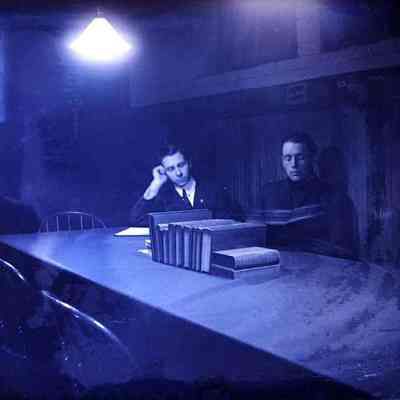A photo of two men sitting at a table.