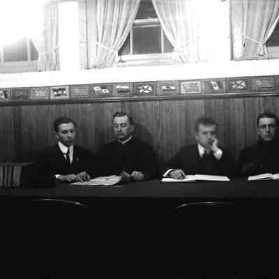 Four men sitting at a table.