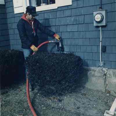 A photo view of a man delivering fuel oil. 1/10/1989.