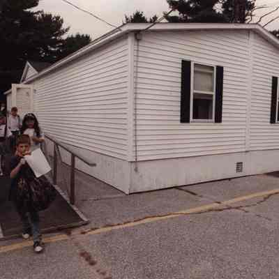 A photo view of school children leaving a portable classroom. 9/13//1989.