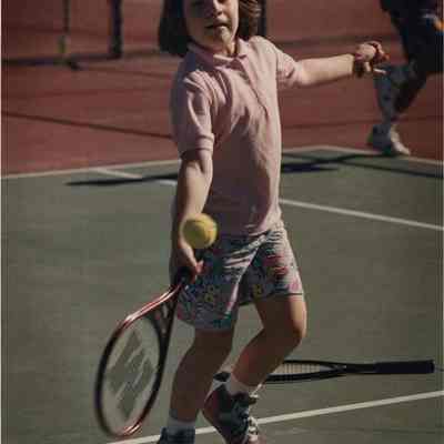 A photo view of Kelly Bard playing tennis. 7/12/1989.