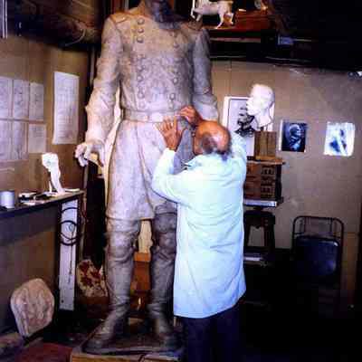 J. Query working on the full size clay model of the JLC statue.