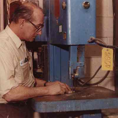 A photo view of man using a bandsaw. 2/13/1990.