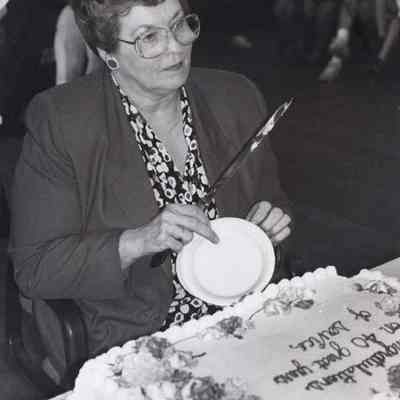 A photo view of a woman at a retirement party.