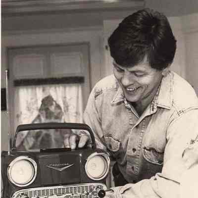 A photo view of a man and a toy car. 11/2/1952.