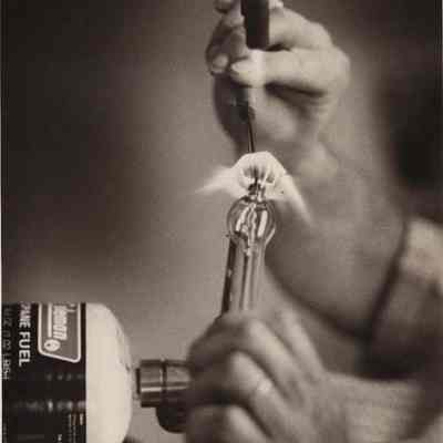 A photo view of Herbert Merrill demonstrating glass blowing. 4/17/1978.