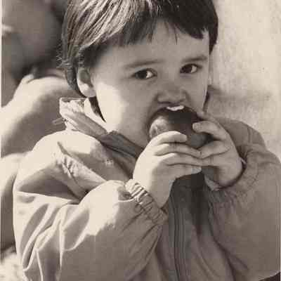 A photo view of Joanie eating a fresh apple. 10/9/1992.