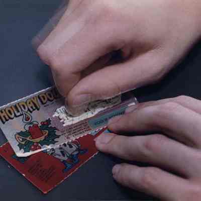 A photo view of scratching a lottery ticket. 11/14/1991.