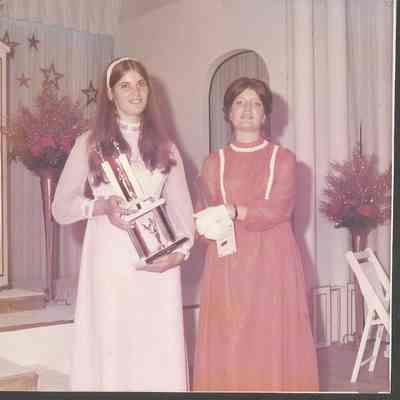 Two of the contestants with their trophies