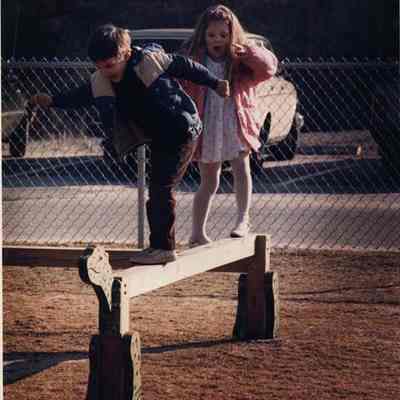 A photo view of 2 children playing. 4/14/1989.