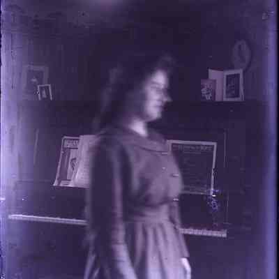 A blurry image of a woman standing.