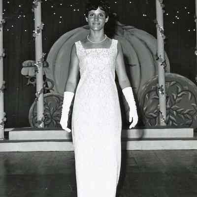 A B/W photograph of an unknown girl wearing a gown.