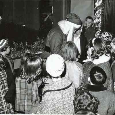 Santa Claus talking to some children
