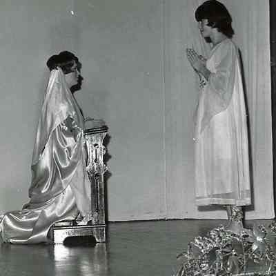 One girl praying to another girl.