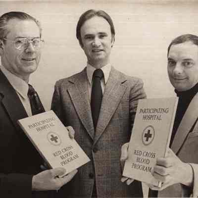 A photo view of three men. 11/23/1976.