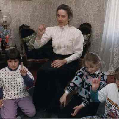 A photo view of Betsy Warner with students. 12/20/1991.