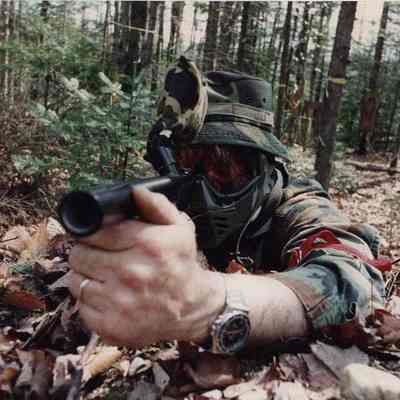 A photo view of a man playing soldier with a paint ball gun. 5/10/1989.