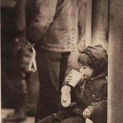 A photo view of a little girl drinking milk. 1/5/1981.