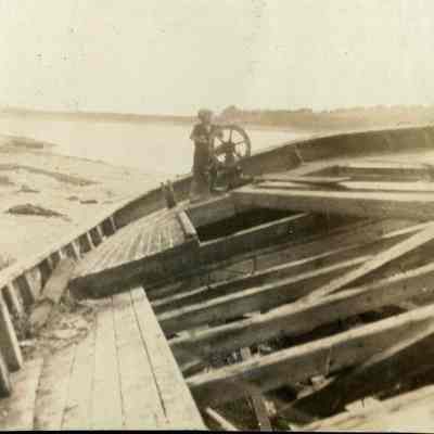 Boy at the Wheel of a Beached Boat