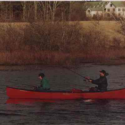 A photo view of two people fishing. 4/12/1988.