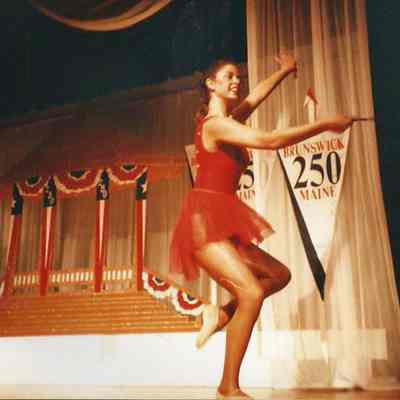 Laurie Deschene MC performing a dance twirl routine.