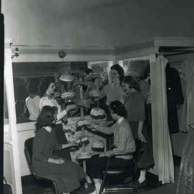 Women trying on hats at Senters or Fashion Shop