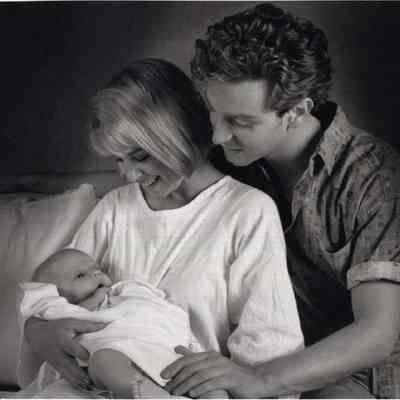 A photo view of two people and a baby. 8/11/1992.