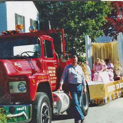 A color photograph of the Teen Queen float with the girls sitting on it.