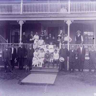 A group of people posing outside a building.