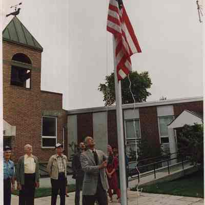 A photo view of raising the flag at a school. 9/15/1987.