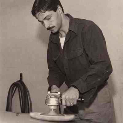 A photo view of a man buffing a car. 11/25/1992.