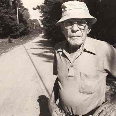 A photo view of a man on a road.