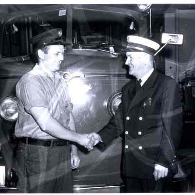 A photo of two men shaking hands.