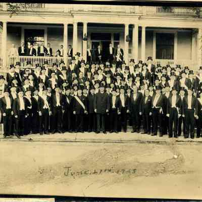 Men in Formal Dress posing in Front of a Building in Brunswick