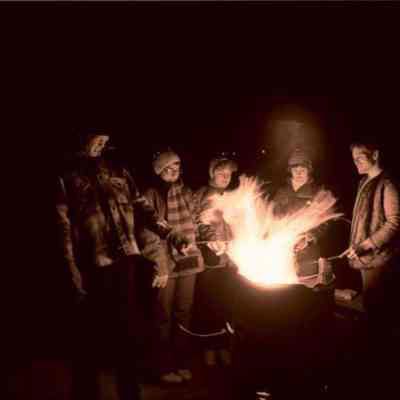 A photo view of people at a bonfire. 12/31/1977.