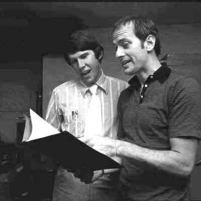 A photo view of two people singing. 7/6/1977.