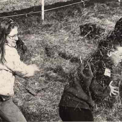 A photo view of children playing in some hay. 10/9/1992.