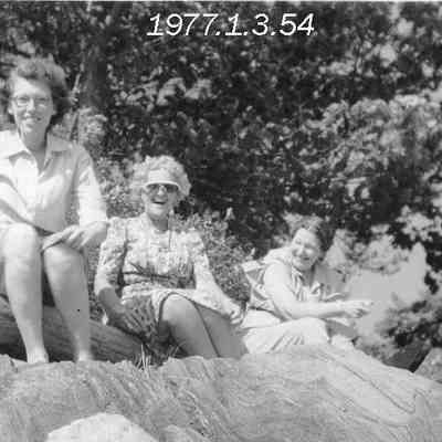 Three Women Sitting on a Rock