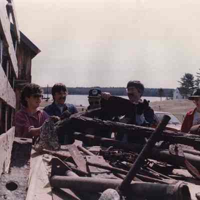 A photo view of 5 people looking at an old anchor. 5/7/1989.