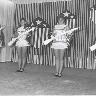 A B/W photograph of the contestant posing in costume