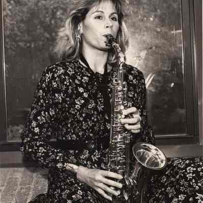 A photo view of a woman playing a saxaphone. 10/4/1992.