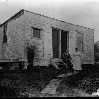 A view of two people in front of a building.