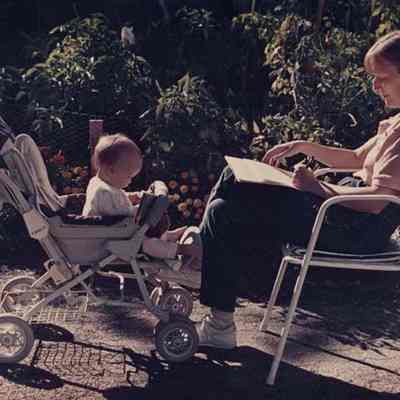 A photo view of a woman and a baby outside. 9/13/1988.