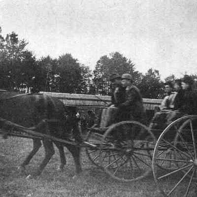 A photo of people in a carriage at Topsham Fair.
